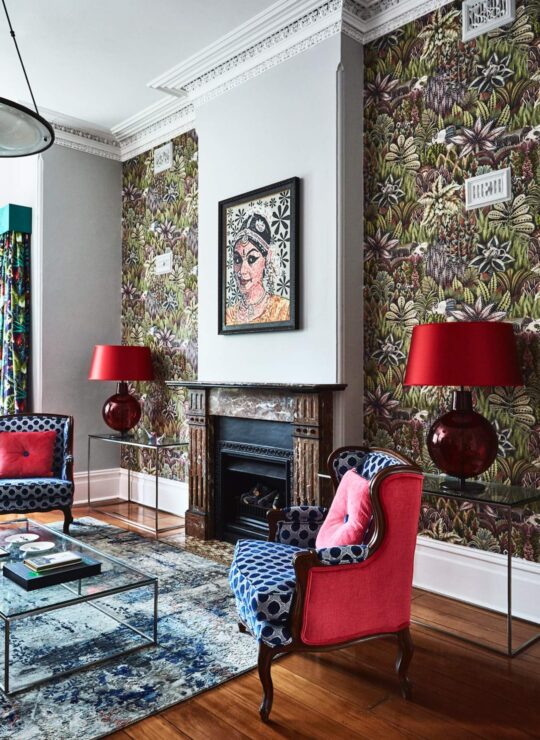 Curated red chairs and lamps with bespoke sustainable wallpaper by Denby Dowling Interior Design