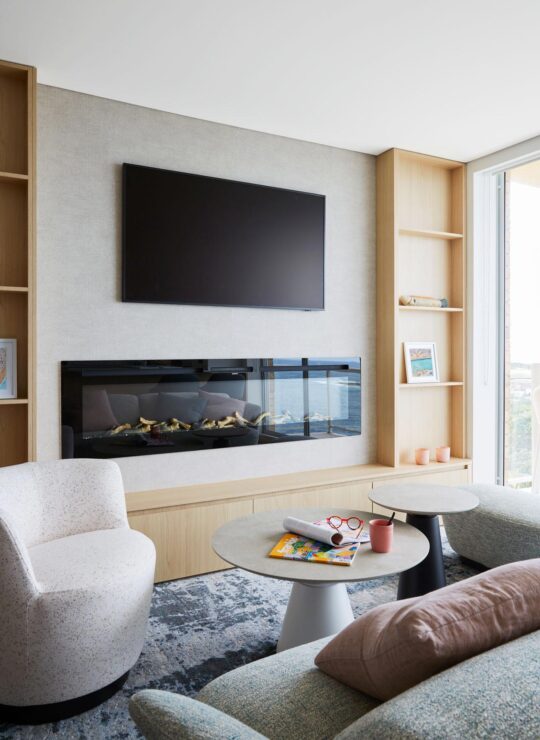 Bespoke living room furniture in front of modern fireplace and TV by Denby Dowling Interior Design